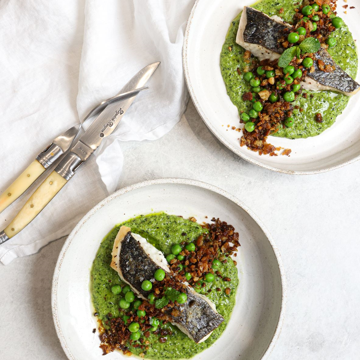 Pan seared cod with truffle, pea, mint purée with a lemon pangrattato